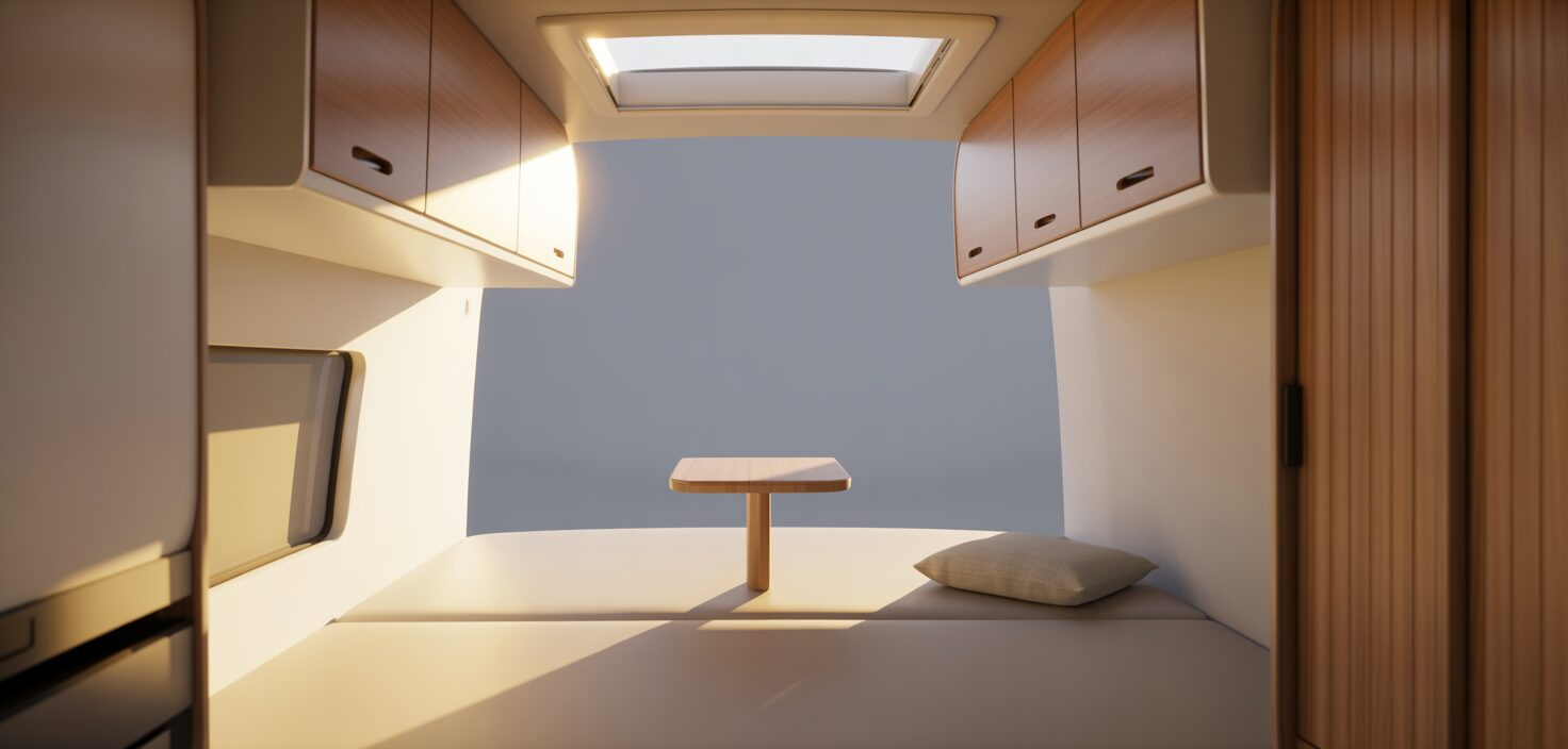 En ljus husbil interiör med minimalistisk inredning och trädetaljer.